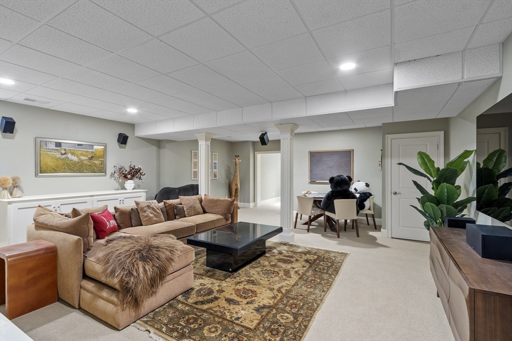 77 Revolutionary Road Concord, MA 01742 - Photo 34 of 42 a living room with furniture and a potted plant