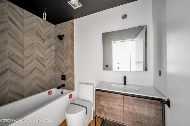 a bathroom with a sink toilet and shower