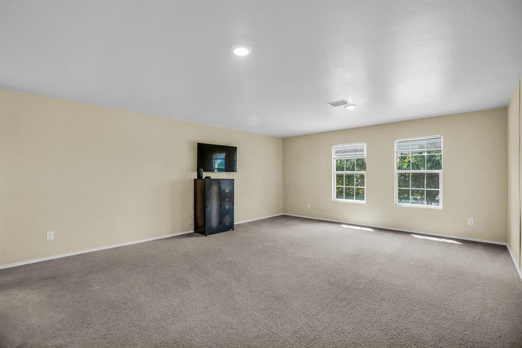 5718 Green Ivy Road Denton, TX 76210 - Photo 22 of 37 Spacious room featuring neutral carpeting, light-toned walls, and recessed lighting