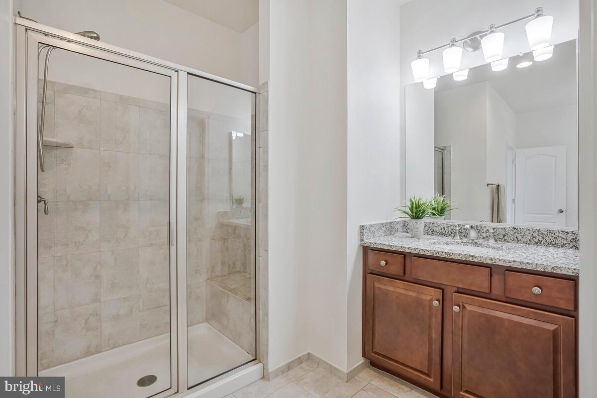 42523 Benfold Square Brambleton, VA 20148 - Photo 14 of 29 a bathroom with a granite countertop sink and a mirror