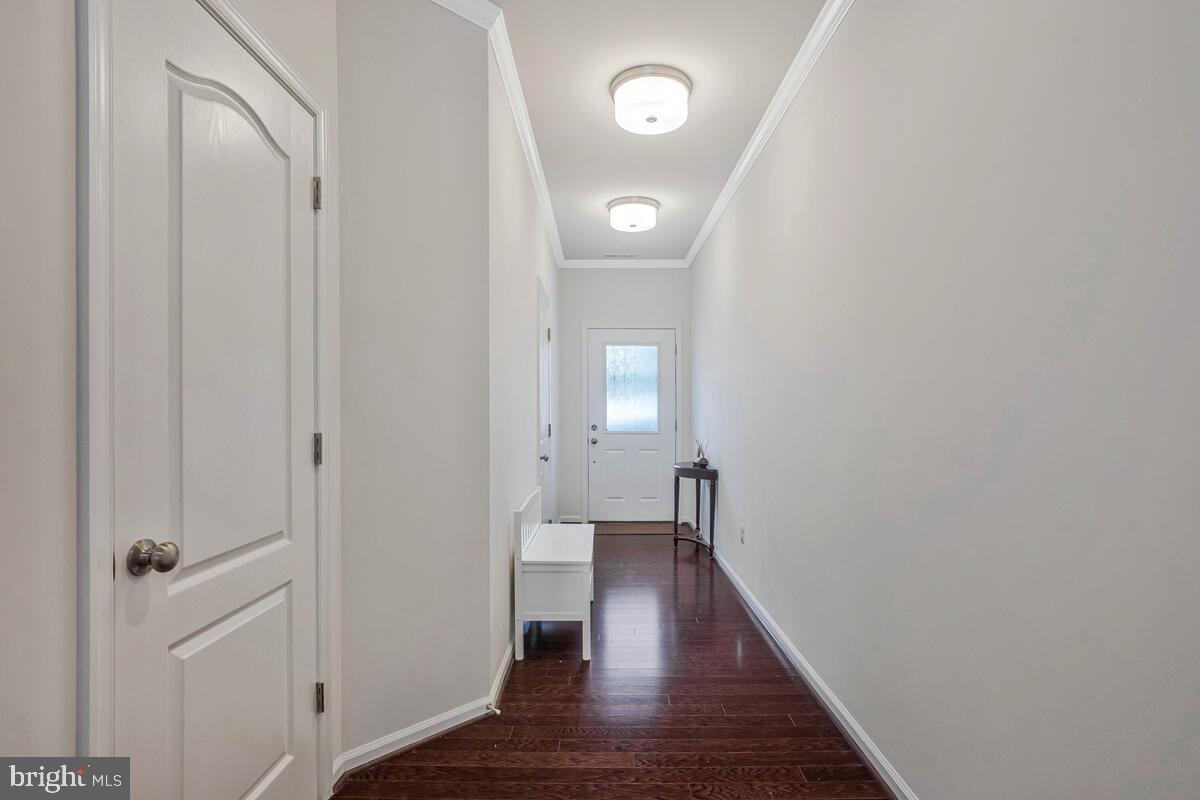 42523 Benfold Square Brambleton, VA 20148 - Photo 15 of 29 a view of a hallway with wooden floor