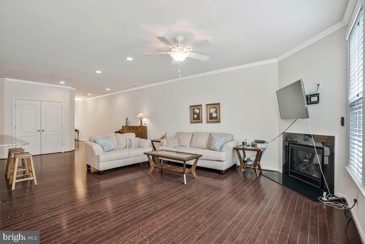 42523 Benfold Square Brambleton, VA 20148 - Photo 23 of 29 a living room with furniture and a fireplace