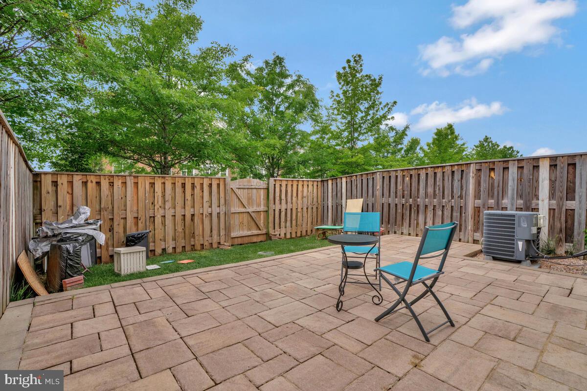 42523 Benfold Square Brambleton, VA 20148 - Photo 27 of 29 a view of a chairs in patio with wooden fence