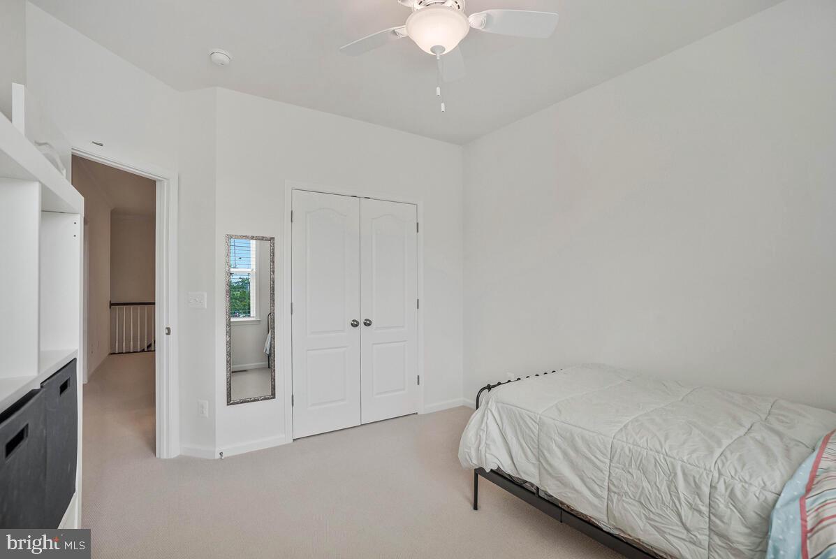 42523 Benfold Square Brambleton, VA 20148 - Photo 6 of 29 a bed room with a bed mirror and a chandelier