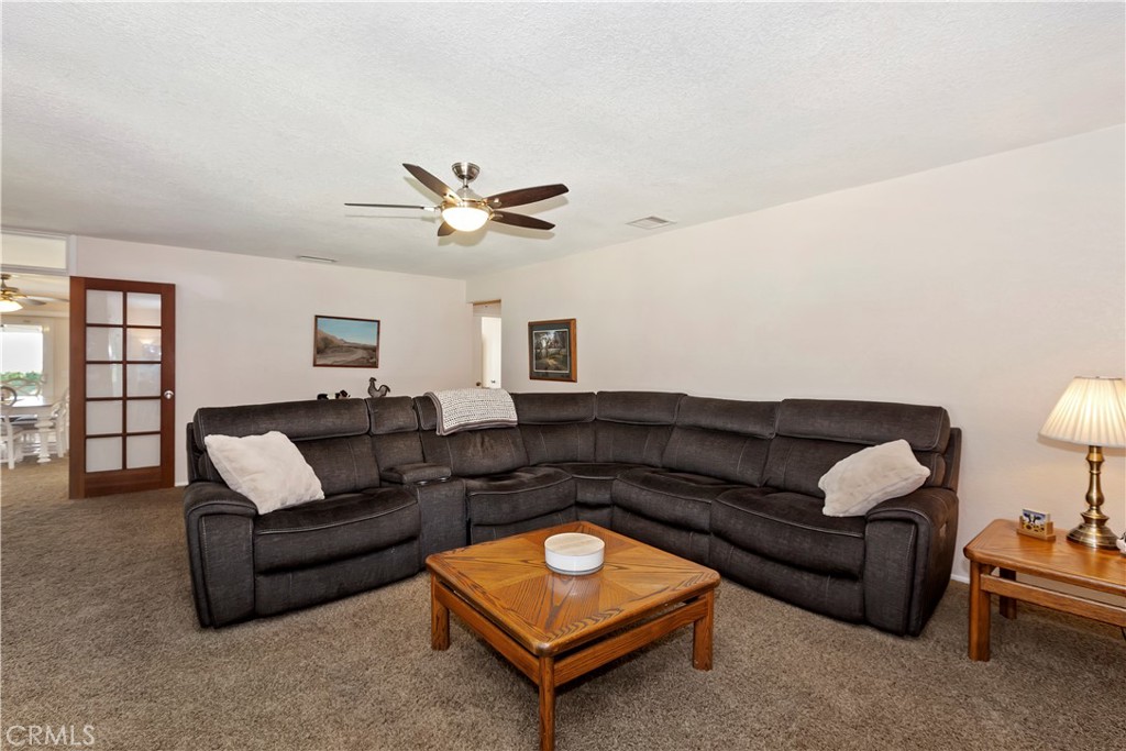 8527 Hillside Road Rancho Cucamonga, CA 91701 - Photo 9 of 50 a living room with furniture a rug and a window