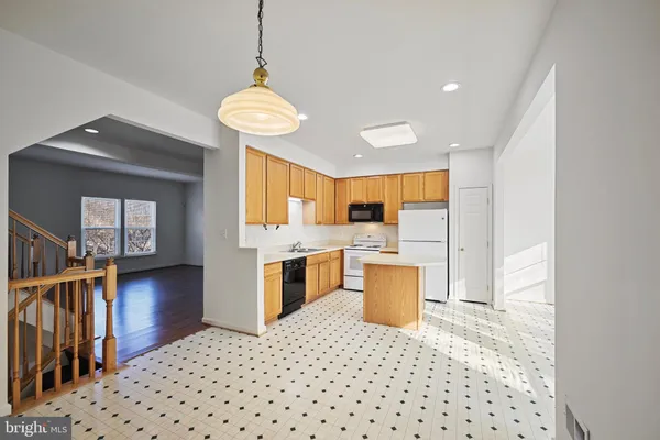 a kitchen with a refrigerator a stove top oven a sink and dishwasher