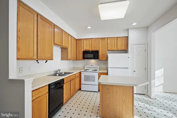 a kitchen with a sink a stove and refrigerator