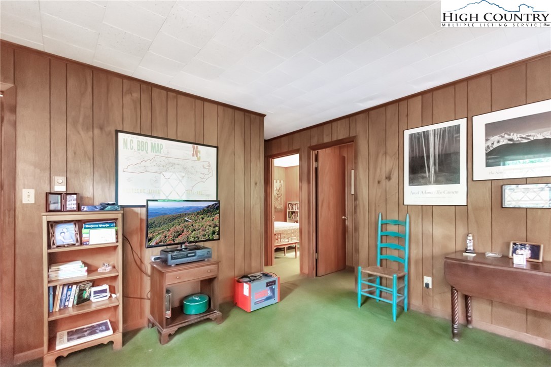 206 Oak Road Beech Mountain, NC 28604 - Photo 23 of 35 a living room with furniture and a bookshelf