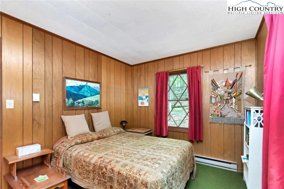 206 Oak Road Beech Mountain, NC 28604 - Photo 28 of 35 a bedroom with a bed and a window