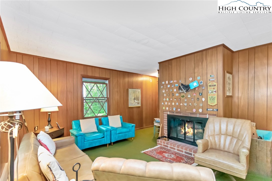 206 Oak Road Beech Mountain, NC 28604 - Photo 3 of 35 a living room with furniture and a fireplace