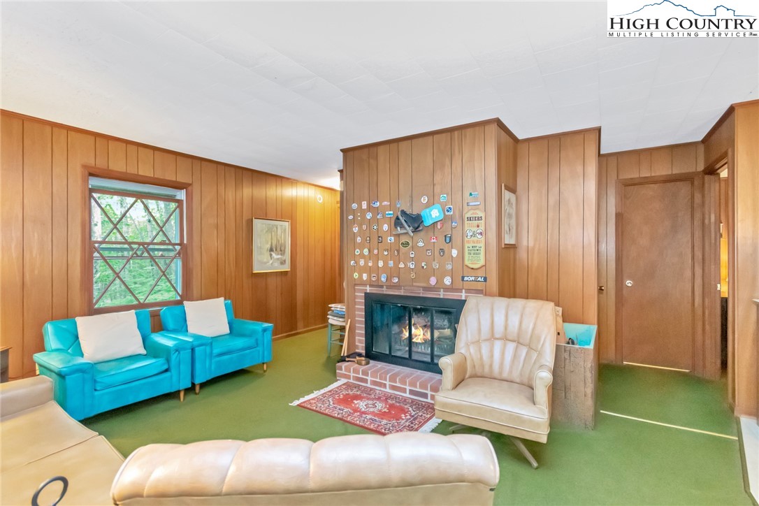 206 Oak Road Beech Mountain, NC 28604 - Photo 4 of 35 a living room with furniture and a fireplace