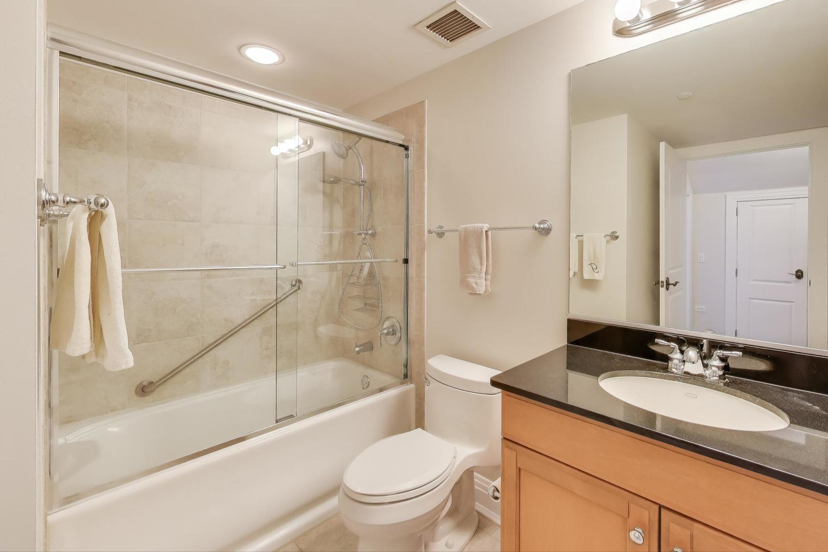 1041 Ridge Road, Unit 503 Wilmette, IL 60091 - Photo 18 of 22 a bathroom with a sink toilet and a bathtub