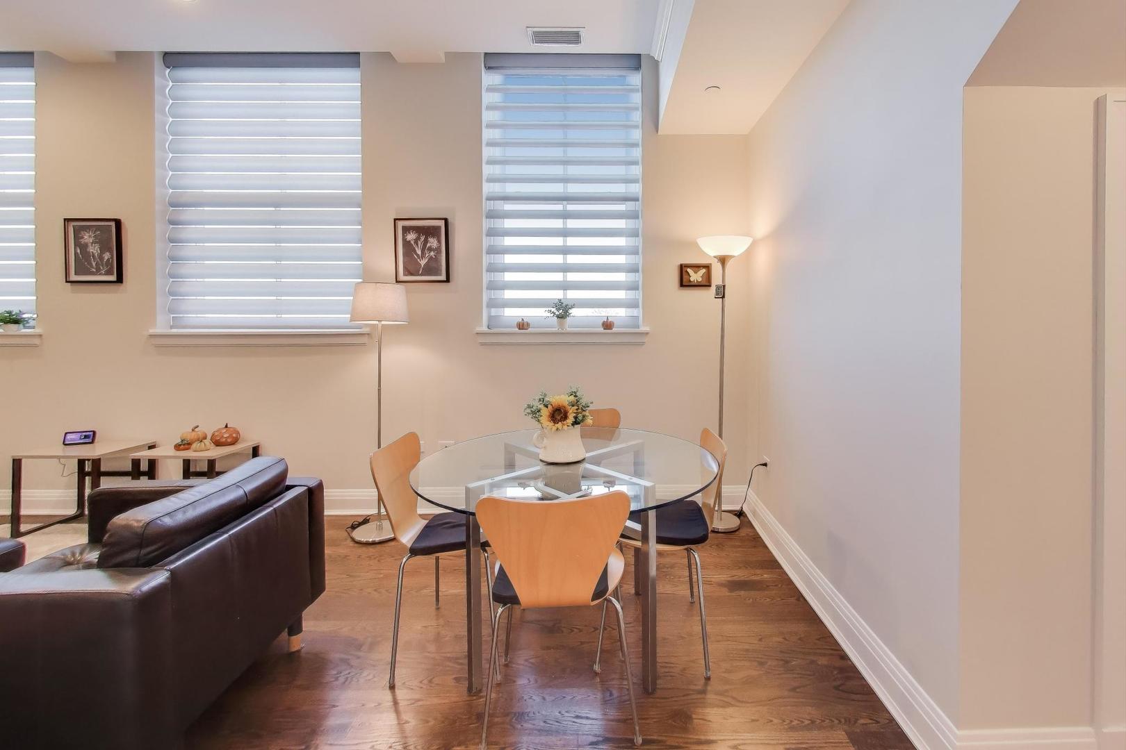 1041 Ridge Road, Unit 503 Wilmette, IL 60091 - Photo 8 of 22 a dining room with furniture and wooden floor