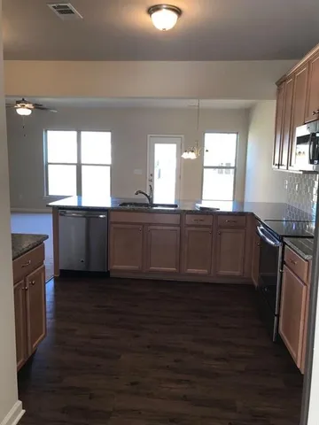 a view of a kitchen counter space and windows