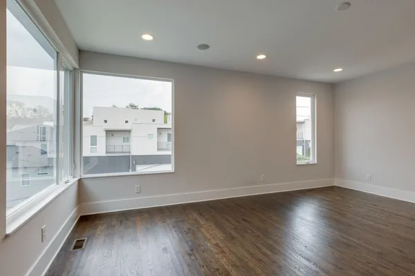 a view of room with window and wooden floor