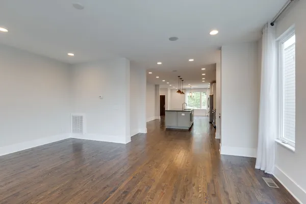 a view of a kitchen with wooden floor and a sink