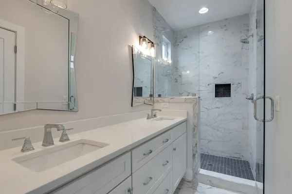 a bathroom with a sink double vanity and a shower