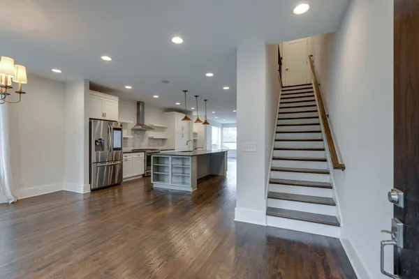 a view of kitchen with sink microwave and refrigerator