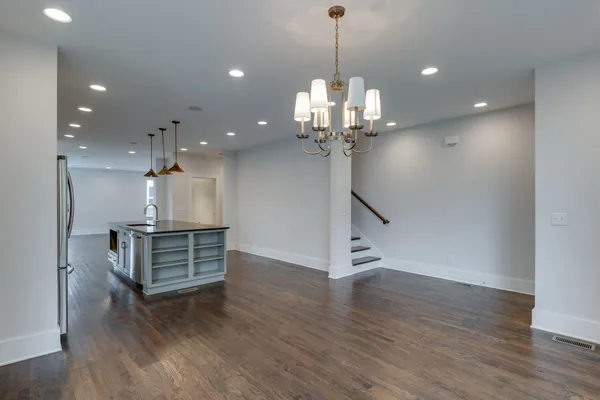 a view of a room with wooden floor and staircase