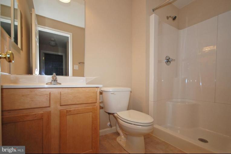 5946 Florey Road Hanover, MD 21076 - Photo 12 of 27 a bathroom with a sink a toilet and shower