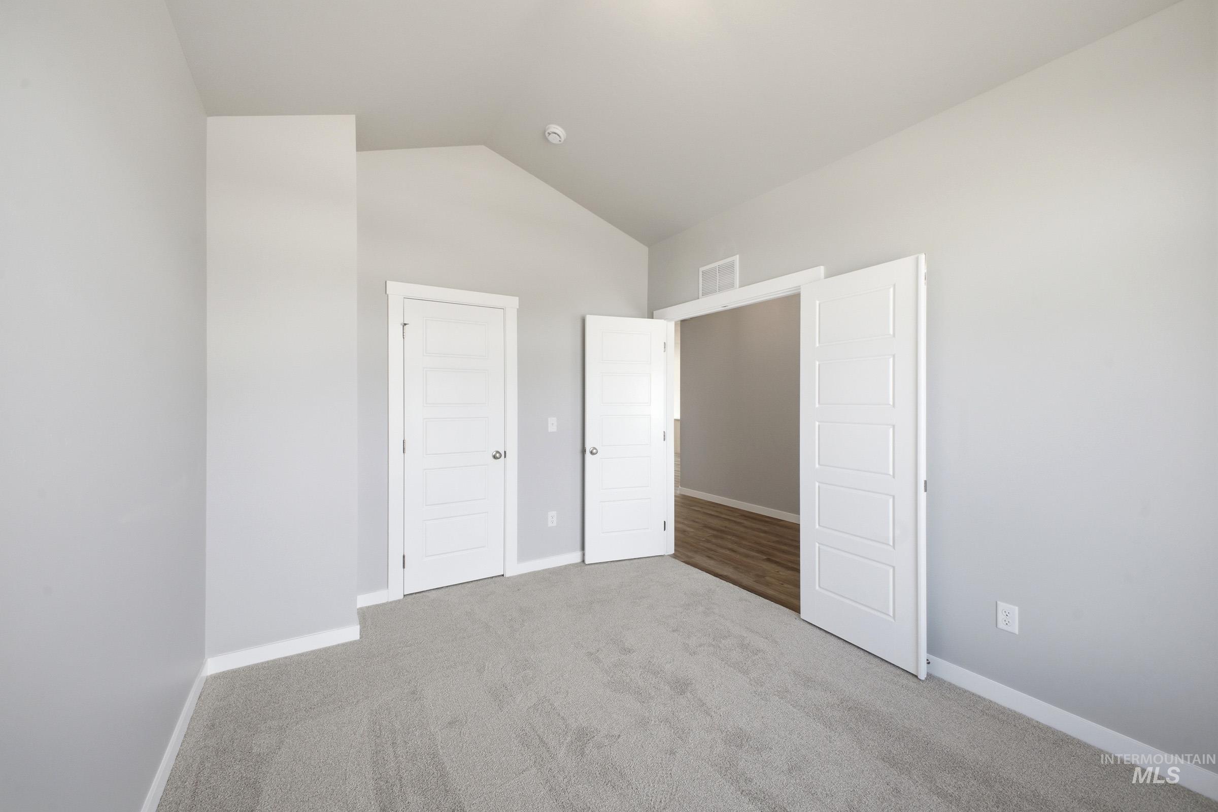 5315 South Memory Avenue Meridian, ID 83642 - Photo 12 of 24 Unfurnished bedroom with carpet floors and lofted ceiling