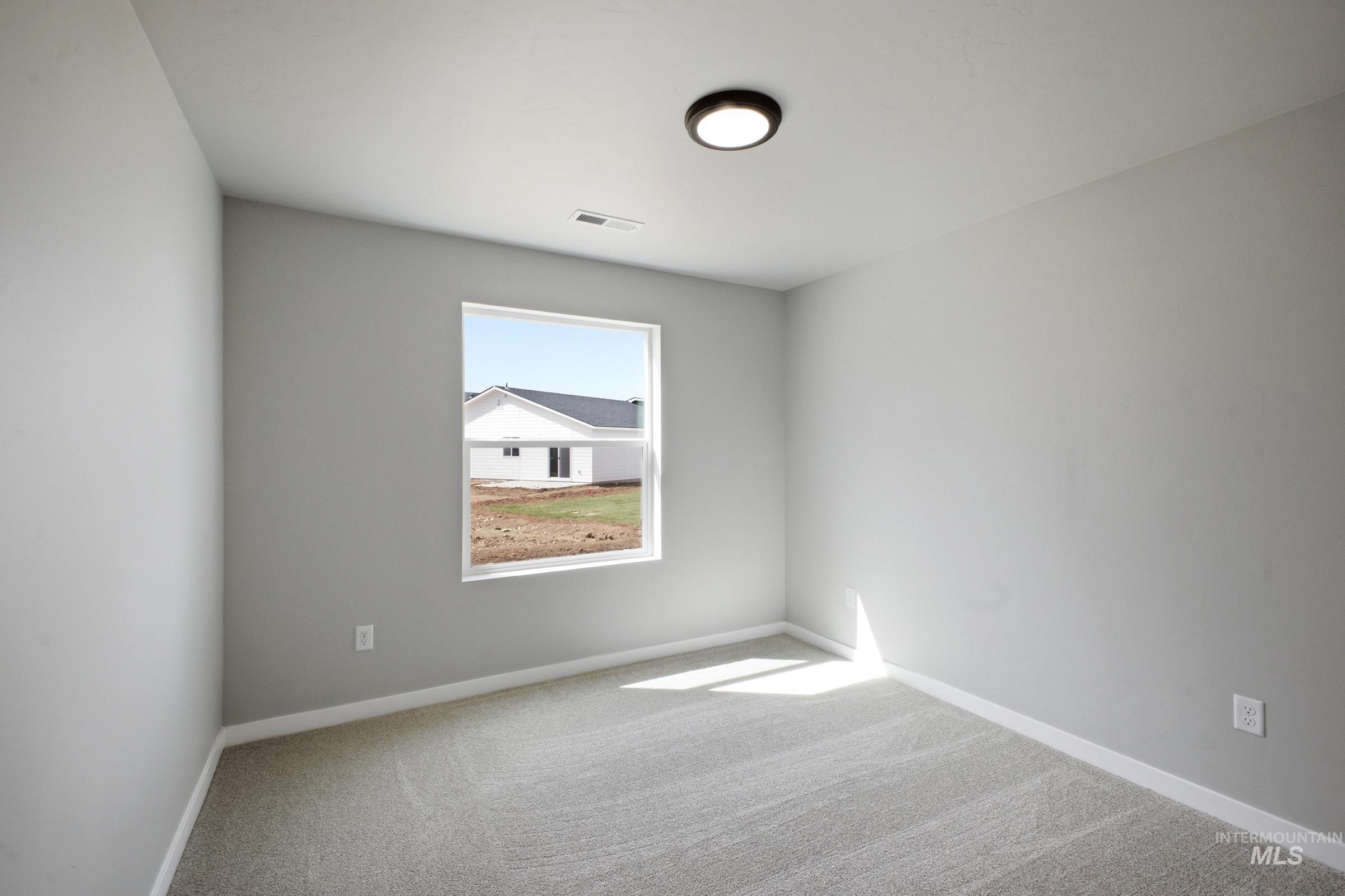 5315 South Memory Avenue Meridian, ID 83642 - Photo 13 of 24 Unfurnished room featuring light carpet and baseboards