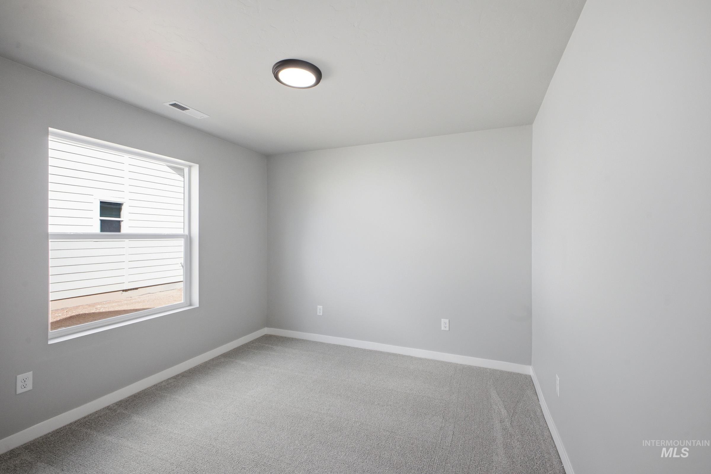 5315 South Memory Avenue Meridian, ID 83642 - Photo 14 of 24 Empty room featuring light carpet and baseboards