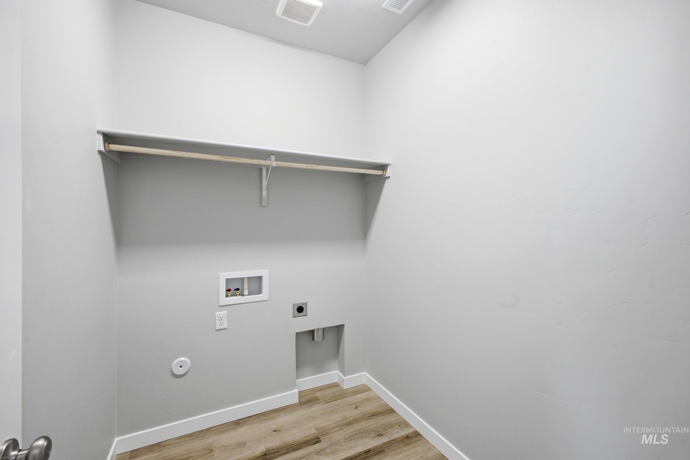 5315 South Memory Avenue Meridian, ID 83642 - Photo 18 of 24 Laundry room with light wood finished floors, hookup for an electric dryer, and hookup for a washing machine