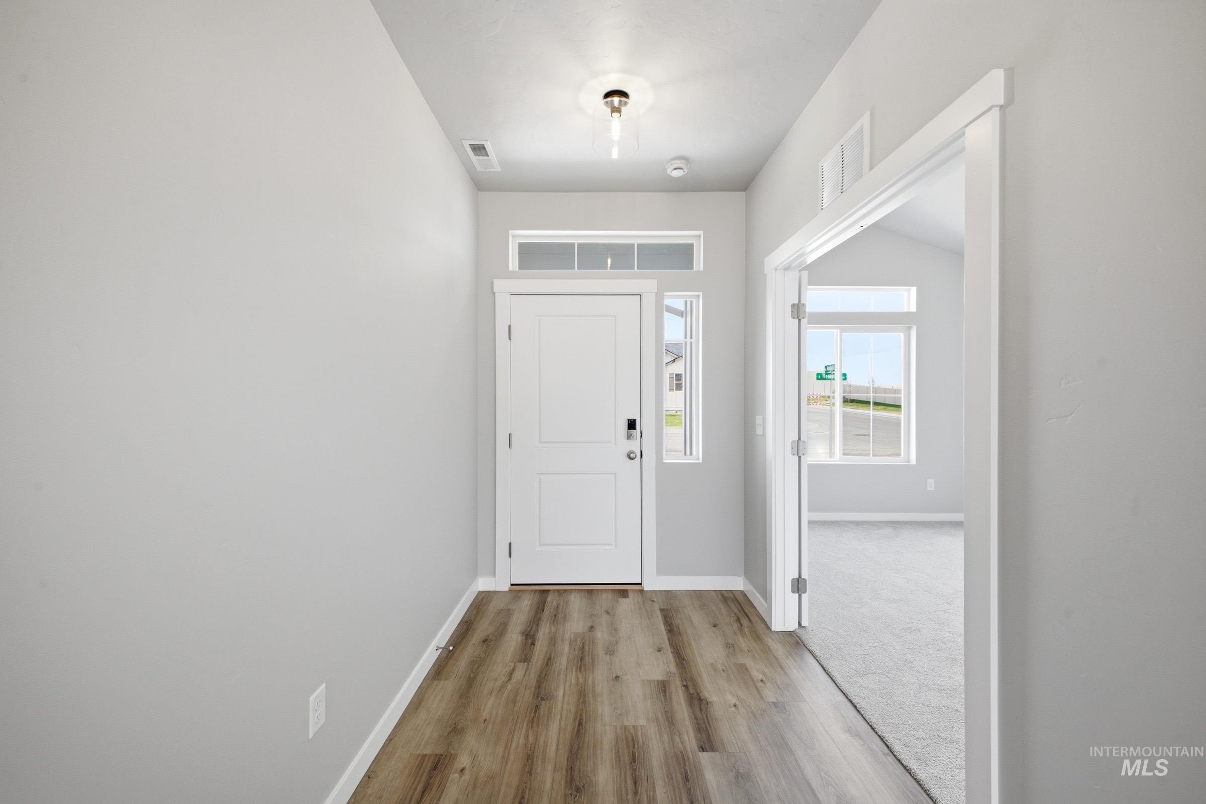 5315 South Memory Avenue Meridian, ID 83642 - Photo 2 of 24 Entryway with baseboards and light wood-style floors