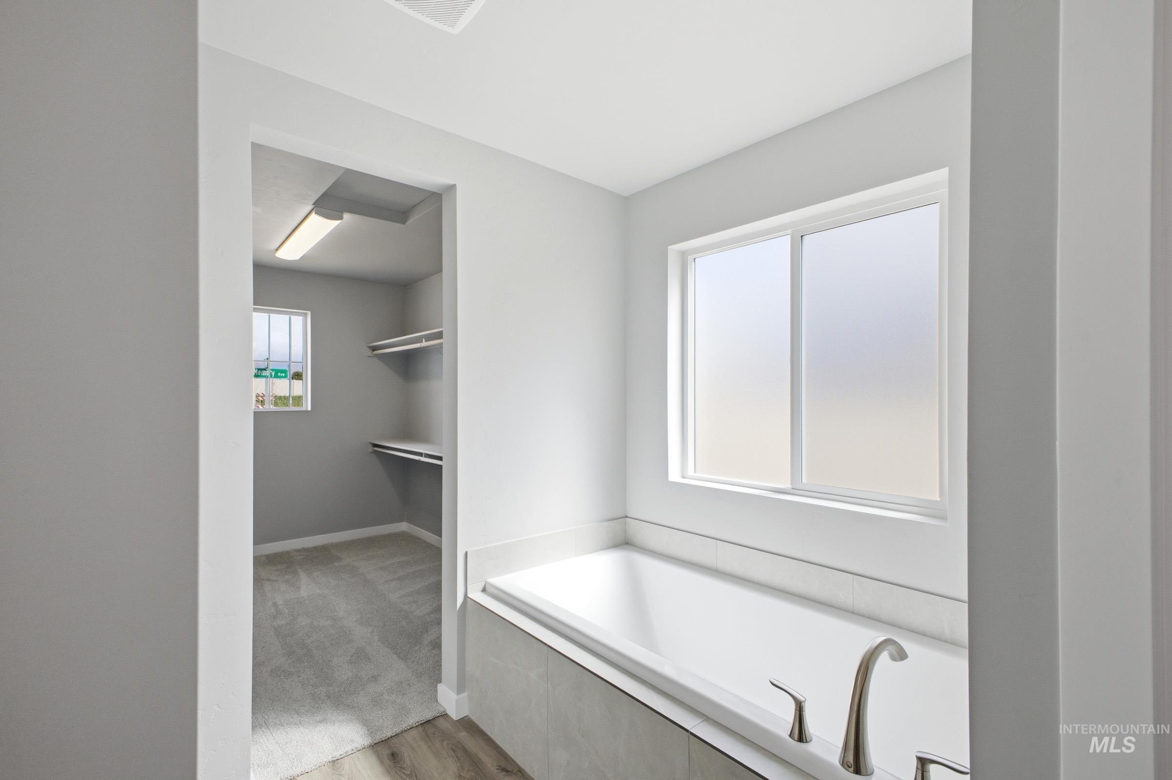5315 South Memory Avenue Meridian, ID 83642 - Photo 22 of 24 Bathroom featuring a bath and light wood-style floors