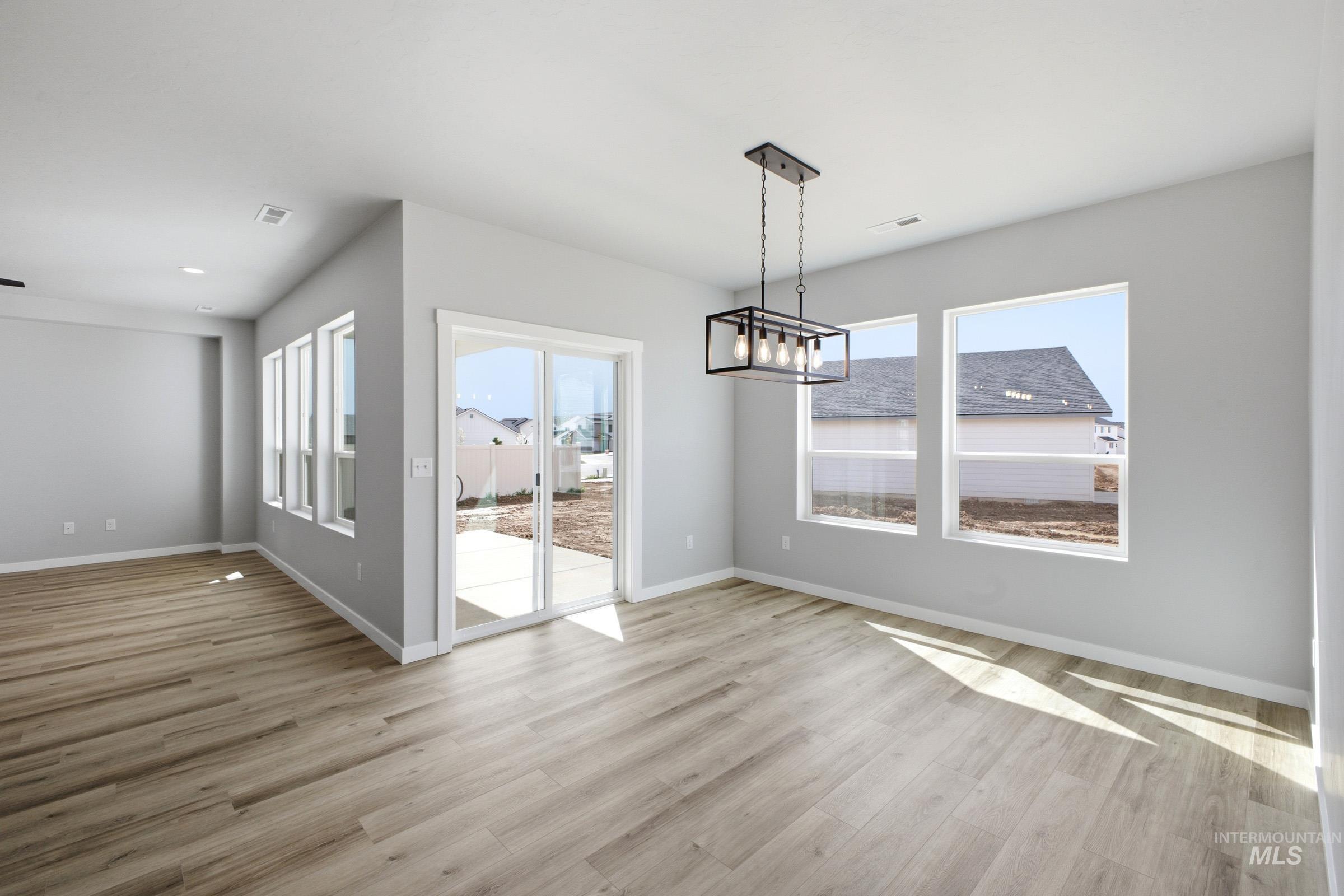 5315 South Memory Avenue Meridian, ID 83642 - Photo 6 of 24 Unfurnished dining area with suspended lighting and light wood-style floors