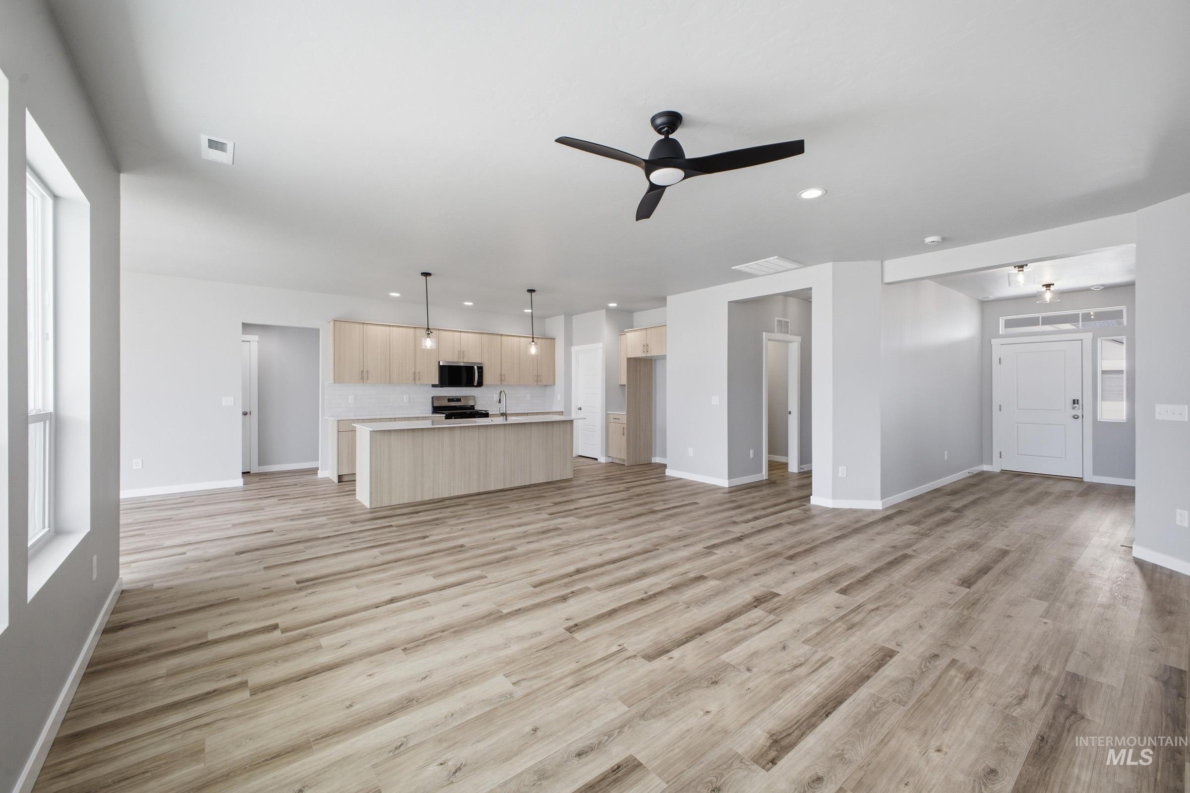 5315 South Memory Avenue Meridian, ID 83642 - Photo 10 of 24 Unfurnished living room with a ceiling fan, light wood-type flooring, and recessed lighting