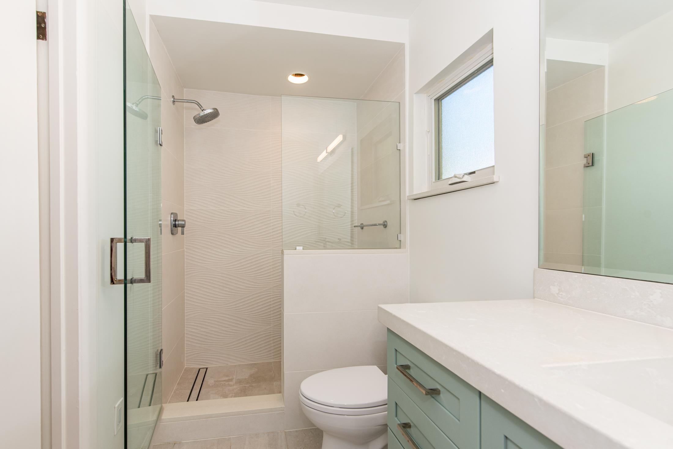 252 South Matanzas Boulevard St. Augustine, FL 32080 - Photo 13 of 32 a bathroom with a sink a toilet a shower and a mirror