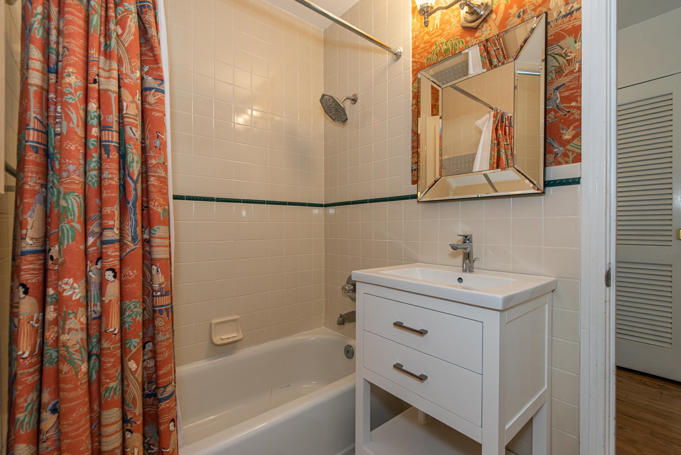 252 South Matanzas Boulevard St. Augustine, FL 32080 - Photo 24 of 32 a bathroom with a sink a mirror and shower