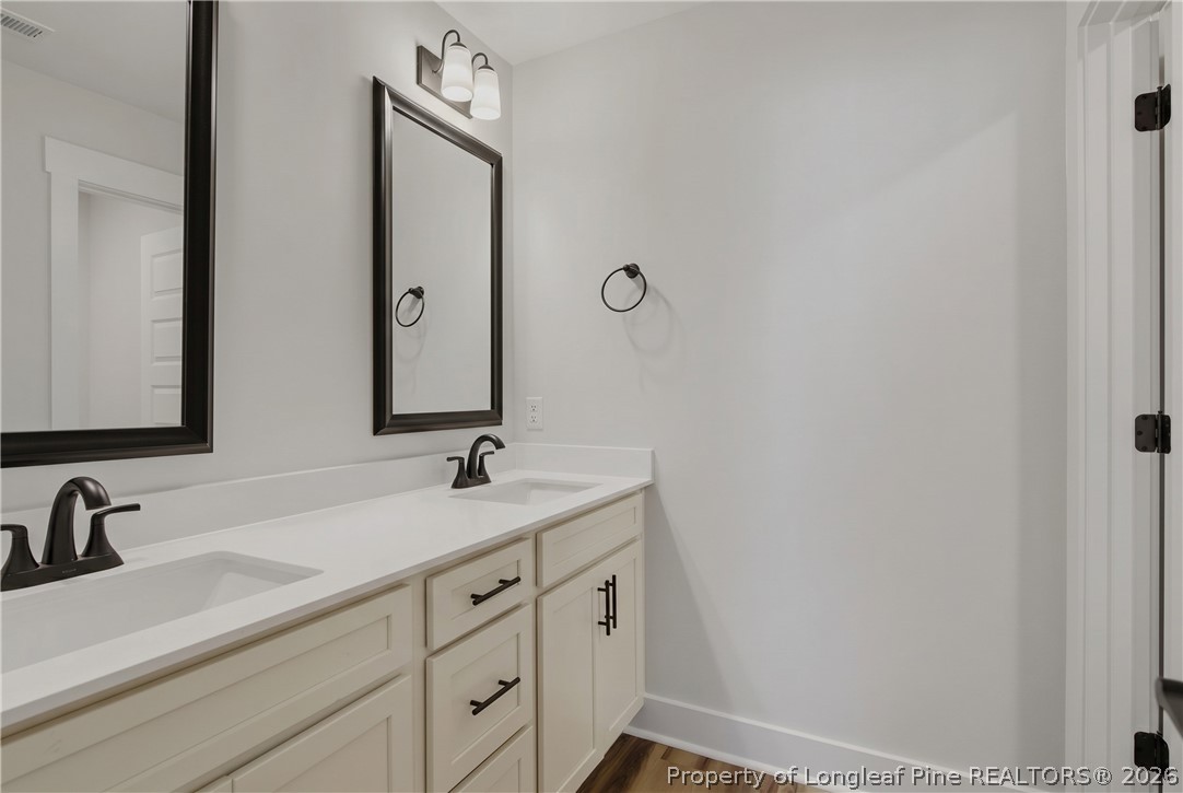 3931 Hamilton Street Hope Mills, NC 28348 - Photo 33 of 50 a bathroom with a double vanity sink and mirror