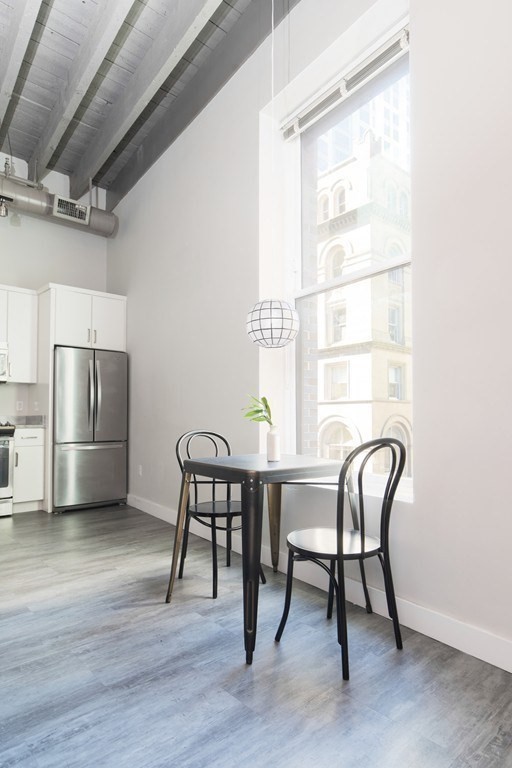 630 Washington Street, Unit 305 Boston, MA 02111 - Photo 5 of 9 a view of a workspace with furniture and a window