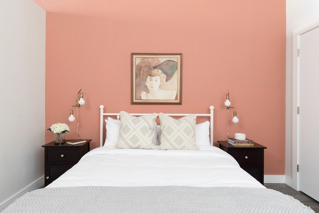 630 Washington Street, Unit 305 Boston, MA 02111 - Photo 7 of 9 a bedroom with a bed and a painting on the wall