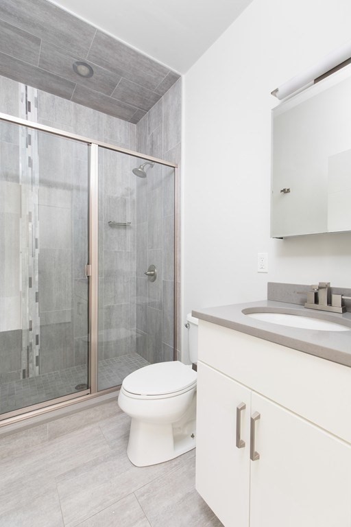 630 Washington Street, Unit 305 Boston, MA 02111 - Photo 8 of 9 a bathroom with a sink a toilet and shower