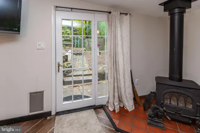 a view of a livingroom with wooden floor and a fireplace