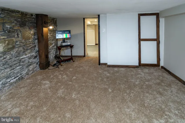 a view of empty room with a fireplace