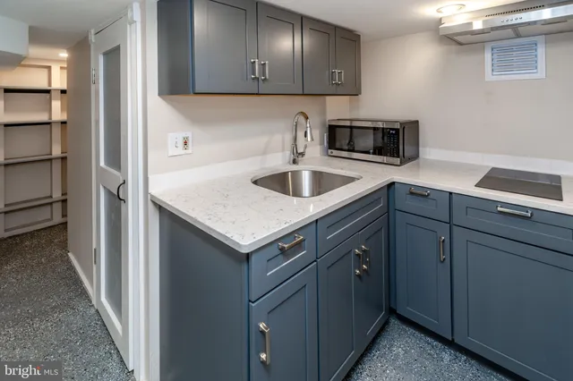 a kitchen with a sink and a stove top oven