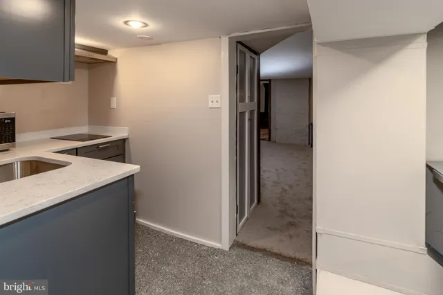 a backyard of a house with table and chairs plants