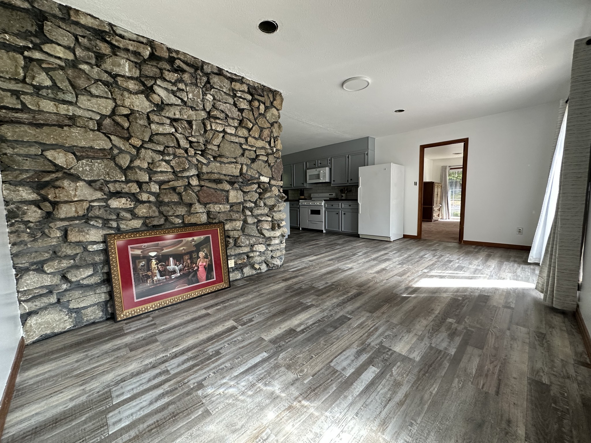 85 John Brown Road Beech Bluff, TN 38313 - Photo 8 of 32 a view of a hallway with wooden floor and a fireplace