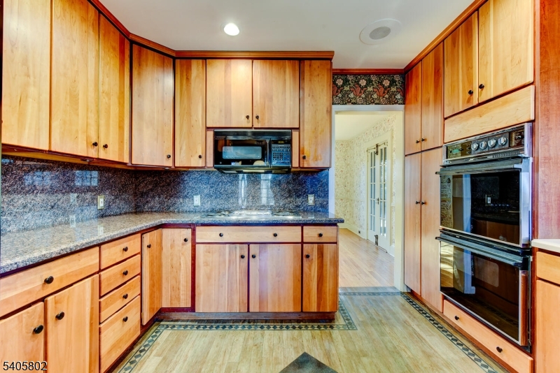 15 Overlook Road Caldwell, NJ 07006 - Photo 18 of 37 a kitchen with stainless steel appliances granite countertop a refrigerator a stove and a wooden cabinets