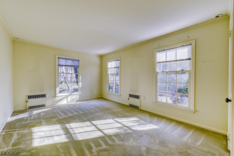 15 Overlook Road Caldwell, NJ 07006 - Photo 23 of 37 a view of an empty room with window and wooden floor