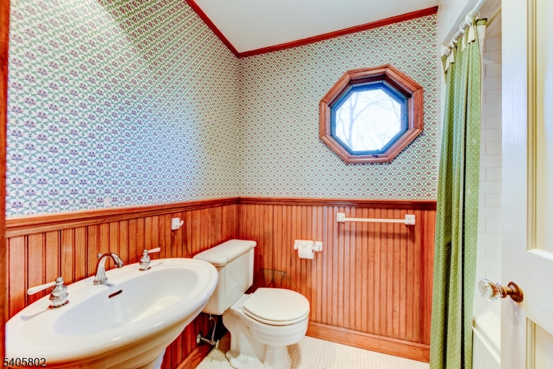 15 Overlook Road Caldwell, NJ 07006 - Photo 30 of 37 a bathroom with a toilet a sink and a mirror