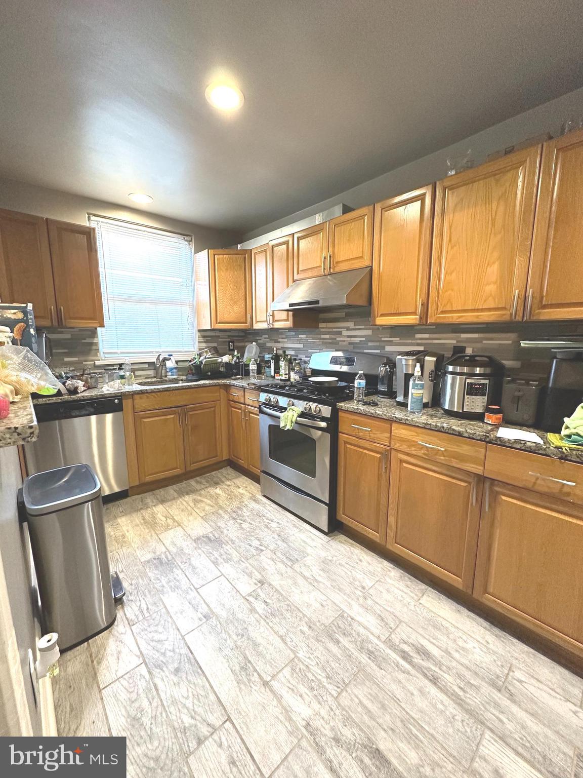 610 Andover Road Upper Darby, PA 19082 - Photo 7 of 22 a kitchen with stainless steel appliances granite countertop a stove top oven a sink dishwasher and cabinets with wooden floor