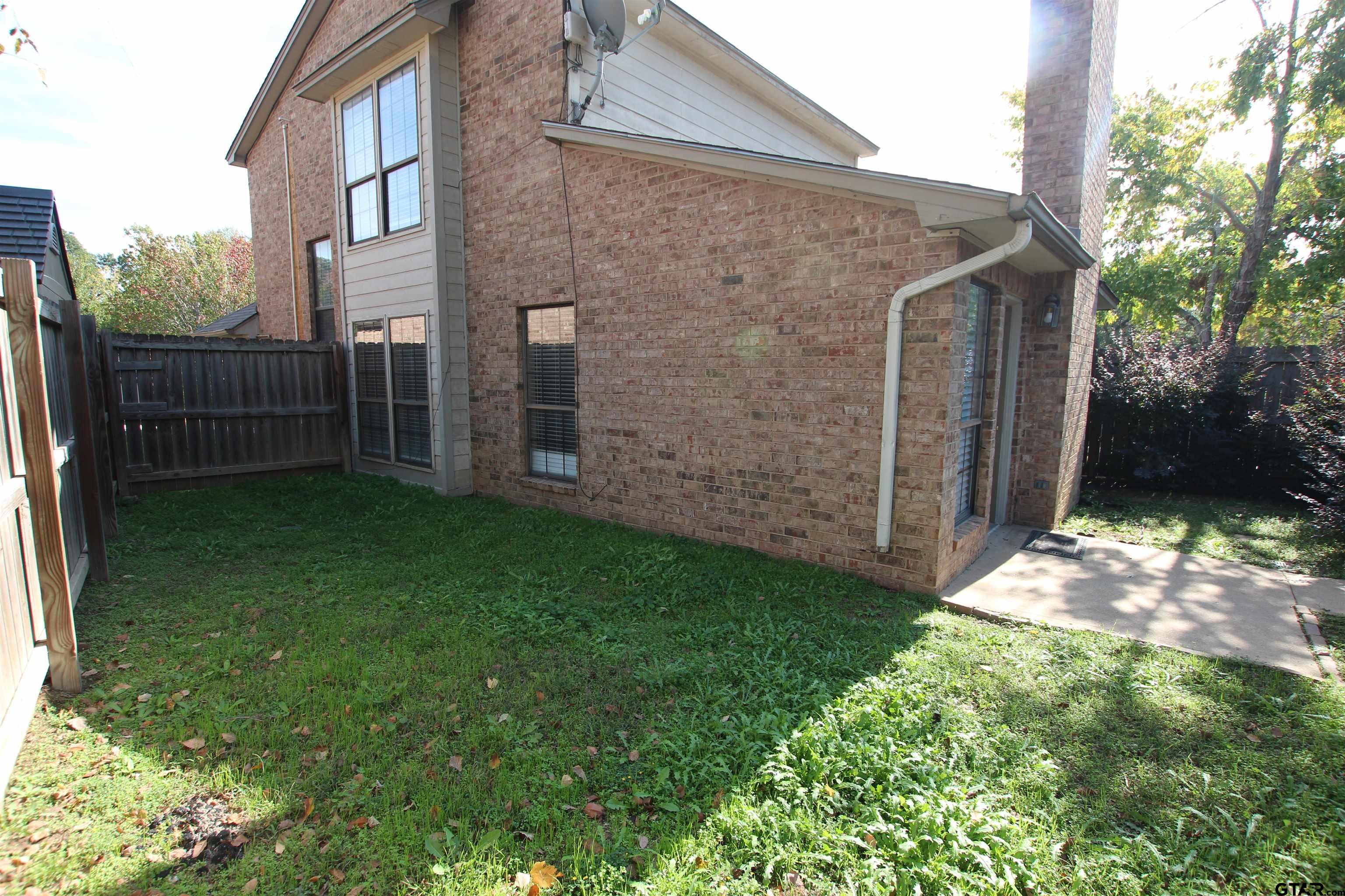 5875 Creekside Circle Tyler, TX 75703 - Photo 32 of 32 a backyard of a house with lots of green space