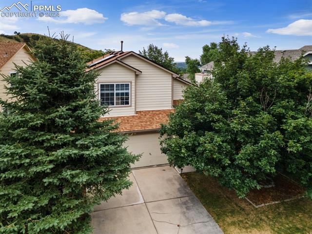 7730 Julynn Road Colorado Springs, CO 80919 - Photo 31 of 48 View of home's exterior with a garage