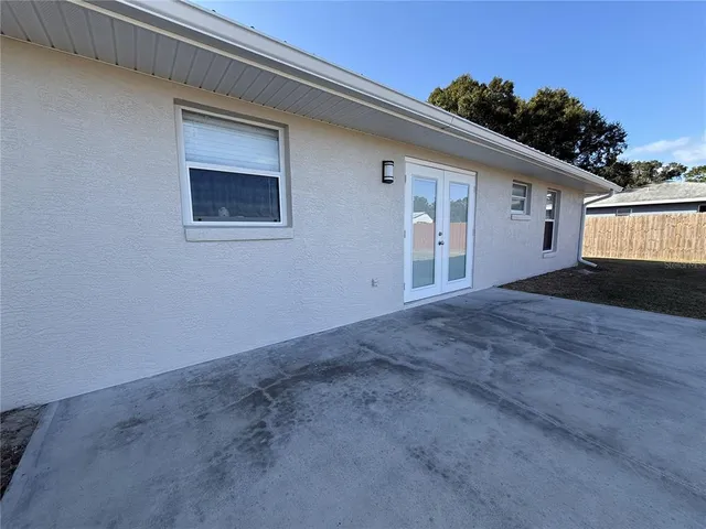 a view of a dry yard with wooden fence